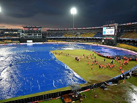 Ground staff cover the pitch after rain stopped play during the Asia Cup 2023 super four ODI match at the R. Premadasa Stadium in Colombo on Sunday.