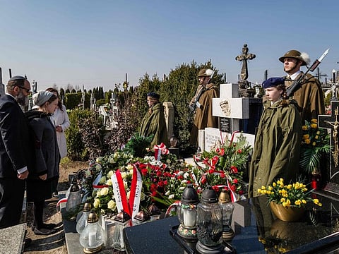 Children and granddaughters of Jewish survivor Abraham Segal pay respect during a ceremony at the grave of The Ulma family, Polish family who sacrificed itself as they were hiding Jews during Holocaust and WWII, on March 17, 2016 in Markowa. A Polish couple and their seven children, killed by Nazis during World War II for hiding Jews, will be beatified on September 10,2023, the first time an entire family is given one of Catholicism's highest honours.  
