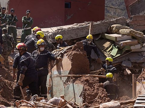 Rescuers attempt to retrieve the body of a deceased boy in Elbour, Morocco