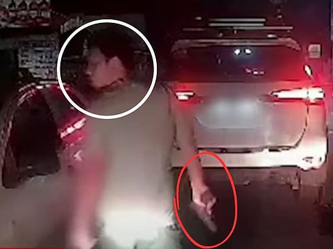 A motorist draws a gun following a road-rage incident in Manila. Moves are afoot in Philippine Congress to pass a law allowing the government to take over in filing cases against angry road users even if their victims show no more interest in attaining justice. 