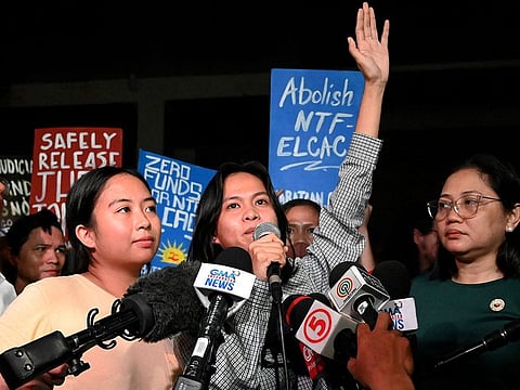 Environmental activists Jhed Tamano (L) and Jonila Castro (C) speak with media representatives at the Commission of Human Rights, in Quezon.