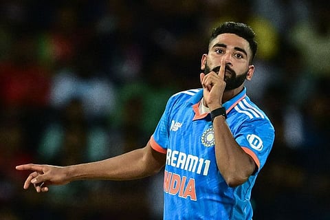 India's Mohammed Siraj celebrates with his trademark silencing the crowd celebration during the final against Sri Lanka on Sunday.