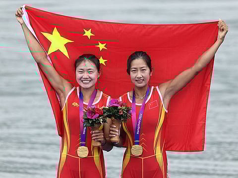 China's Shiyu Lu and Shuangmei Shen celebrate on the podium after winning the the gold medal in the Women's Double Sculls.