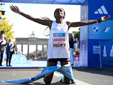 Ethiopia's Tigist Assefa celebrates after smashing the women's marathon world record to win the women's race of the Berlin Marathon on Sunday.