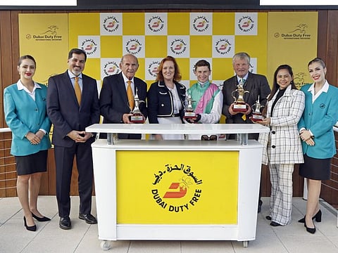 Salah Tahlak, Colm McLoughlin, Sinead El Sibai, Oisin Murphy, Juddmonte's Simon Mockridge and Elisa Yana receive the trophy after Array's victory in the Dubai Duty Free Mill Reef Stakes at Newbury on Saturday.