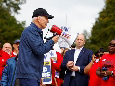 US President Joe Biden joins striking members of the United Auto Workers (UAW) on the picket line outside the GM's Willow Run Distribution Center, in Bellville, Wayne County, Michigan on September 26, 2023. 