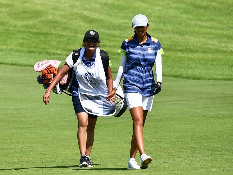 India's Aditi Ashok (R) and caddie, her mother Maheshwari