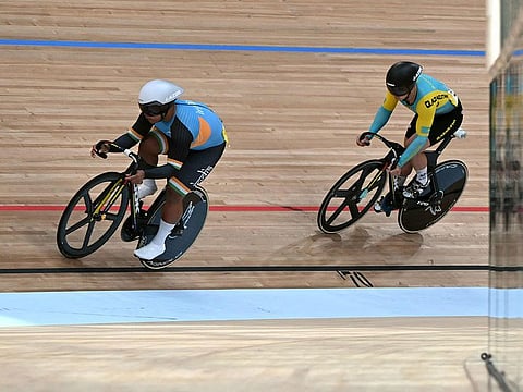 India's David Beckham Elkatohchoongo (L) and Kazakhstan's Sergey Ponomaryov (R) compete in the men's sprint 1/16 finals of the cycling track event during the 2022 Asian Games in Hangzhou in China's eastern Zhejiang province.