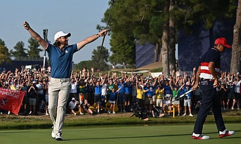 Europe's English golfer, Tommy Fleetwood celebrates the winning putt on the 17th green during his singles match against US golfer Rickie Fowler on the final day in the 44th Ryder Cup at the Marco Simone Golf and Country Club in Rome on Sunday.