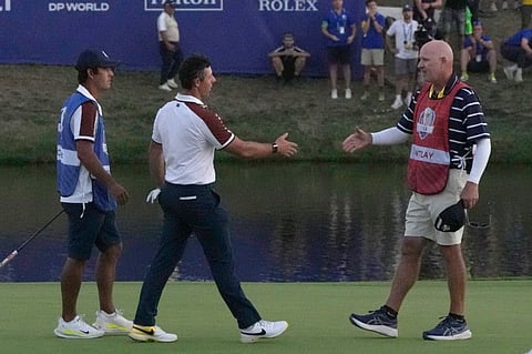 Europe's Rory Mcilroy greets United States' Patrick Cantlay 's caddie Joe LaCava on the 18th green following the end of during the afternoon Fourballs matches at the Ryder Cup in Guidonia Montecelio, Italy, on Saturday.