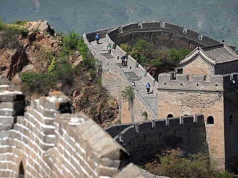 Visitors walk along the Jinshanling section of the Great Wall of China in northern China's Hebei Province.