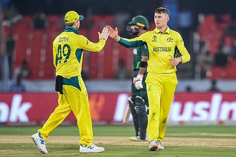 Australia's Marnus Labuschagne (right) celebrates with teammate after taking the wicket of Pakistan's Shadab Khan during a warm-up match at the Rajiv Gandhi International Cricket Stadium in Hyderabad on Tuesday.