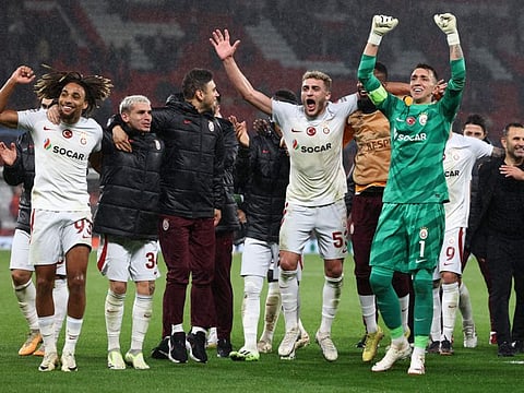Galatasaray players celebrate after winning the Champions league group A match against Manchester United at Old Trafford stadium in Manchester on Tuesday.