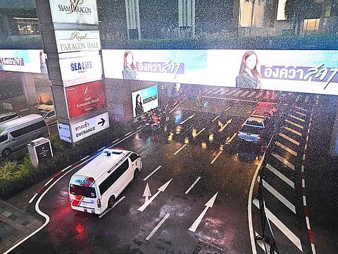An ambulance arrives at Siam Paragon mall in downtown Bangkok on October 3, 2023. Hundreds of people fled a shooting incident at the shopping mall in downtown Bangkok on October 3, 2023. 
