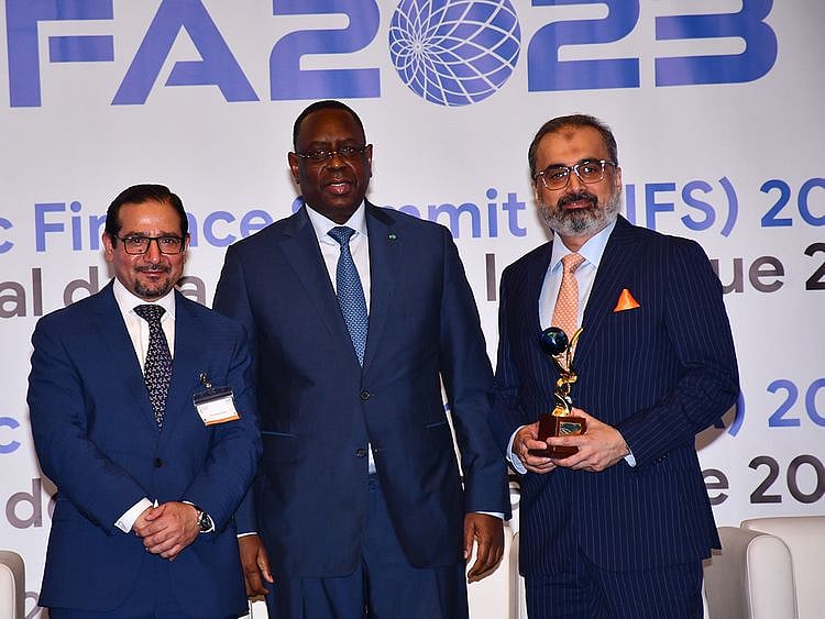 From left to right: Dr Humayon Dar, Director General of the Cambridge Institute of Islamic Finance, Macky Sall, President of Senegal, and Adnan Fasih, Group Head of Islamic Banking at Habib Bank AG Zurich with the Championship Award for Global Islamic Banking Franchise at GIFA 2023