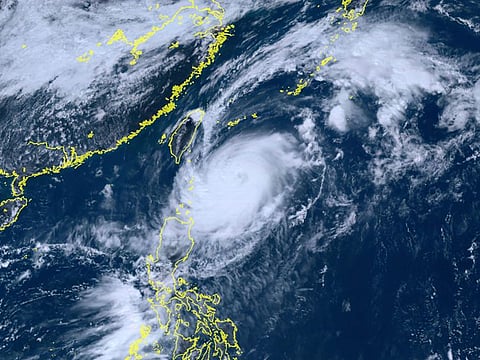  This satellite image taken by Himawari-8, a Japanese weather satellite, and provided by National Institute of Information and Communications Technology, shows Typhoon Koinu, center, approaching Taiwan Tuesday, Oct. 3, 2023. (