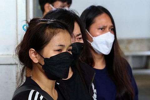 Relatives of a victim from Myanmar mourn on October 4, 2023 at the Central Institute of Forensic Science following Thai police's arrest of a teenage gunman who is suspected of killing foreigners and wounding other people in a shooting inside the luxury Siam Paragon shopping mall in Bangkok a day earlier.  