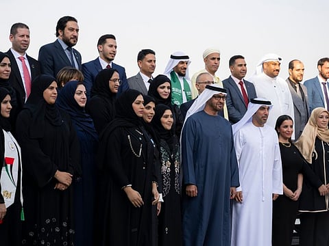 His Highness Sheikh Mohamed bin Zayed Al Nahyan, President of the United Arab Emirates (L), receives teachers from the UAE education sector, during a reception to celebrate World Teacher’s Day, at the Sea Palace.