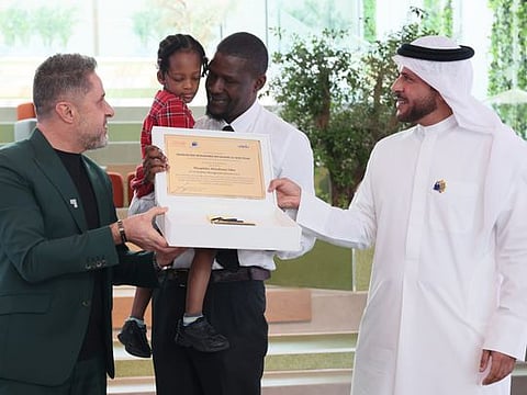 Winner Theophilus Efetobome Obie accepts an award with his daughter from Major-General Obaid Muhair bin Suroor, Deputy Director-General of the General Directorate of Residency and Foreigners Affairs (GDRFA) in Dubai, and Chairman of the Taqdeer Award and Fares Saeed, Chairman and CEO of SEE holding, at the Wajadto Nafsi press conference and Taqdeer Award on October 5, 2023. 