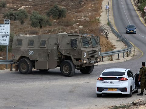 An Israeli military vehicle is stationed near the West Bank city of Tulkarem where two Palestinians were killed during clashes with Israeli forces on October 5, 2023.  