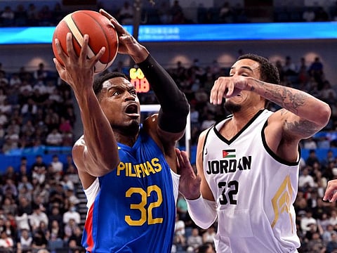 Philippines' player Justin Brownlee (left) is challenged by Jordan's John Bohannon during the men's gold medal basketball game on Friday.