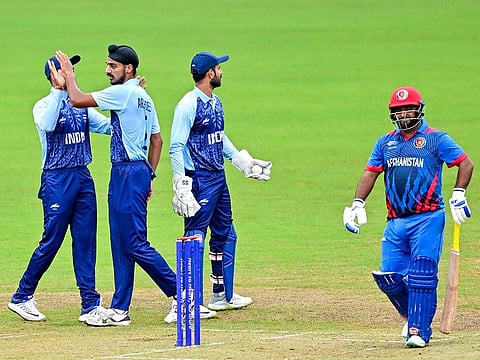 India's Arshdeep Singh (2nd-L) celebrates with teammates after the dismissal of Afghanistan’s Mohammad Shahzad (R) in the men’s final cricket match during the Hangzhou 2022 Asian Games in Hangzhou, in China's eastern Zhejiang province on October 7, 2023. 