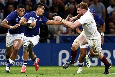 Samoa's scrum-half Melani Matavao (second from left) runs with the ball past England's lock Ollie Chessum during the Rugby World Cup Pool D match at the Stade Pierre-Mauroy in Villeneuve-d'Ascq on Saturday.