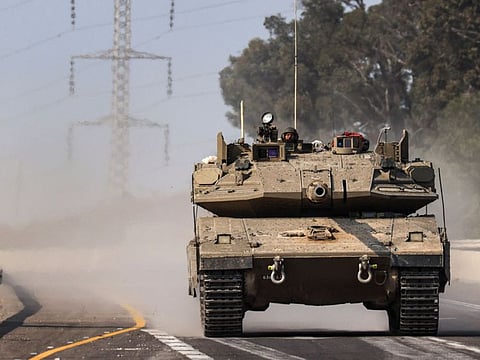 An Israeli tank rolls on a highway near the southern city of Sderot on October 8, 2023.  