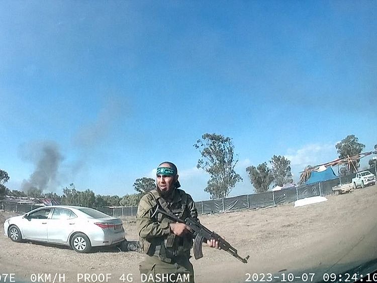  A grab from a UGC video posted on Telegram on October 9, 2023, shows a Palestinian militant walking around the Supernova music festival, near Kibbutz Reim in the Negev desert in southern Israel.  
