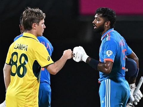 Australian spinner Adam Zampa congratulates Hardik Pandya (right) after India won the World Cup match in Chennai on Sunday.