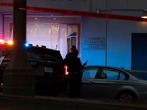 Police officers are seen outside the visa office of the Chinese consulate, where earlier a vehicle crashed into the building, in San Francisco, California.