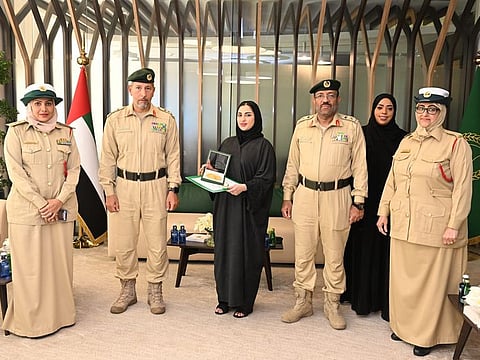 Nouf Al Mazrouei with her certificate of appreciation from Dubai Police 