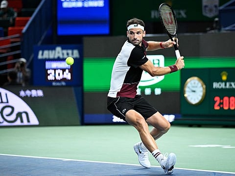 Bulgarias Grigor Dimitrov powers a backhand return to Spains Carlos Alcaraz during their men's singles at the Shanghai Masters on Wednesday.