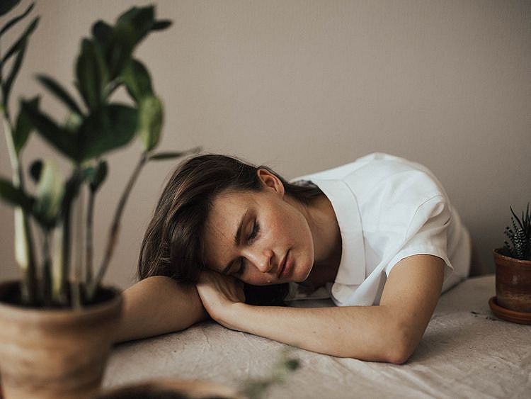 Person putting their head on a table