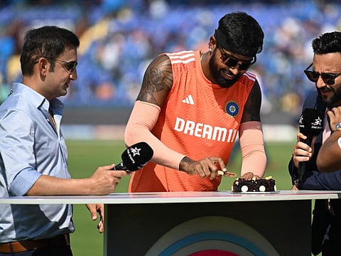 Indian all-rounder Hardik Pandya cuts a cake to celebrate his birthday before the start of the World Cup match against Afghanistan in New Delhi on Wednesday.