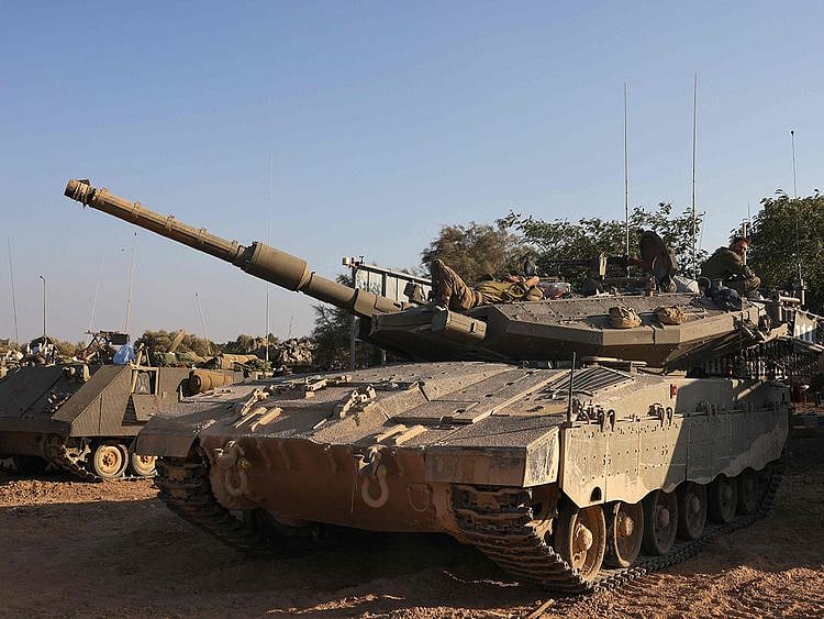 Israeli tanks are positioned near the border with Gaza on October 12, 2023. Israel appeared to be readying for a possible ground invasion of Gaza, but faces the threat of a multi-front war after also coming under rocket attack from militant groups in neighbouring Lebanon and Syria.  
