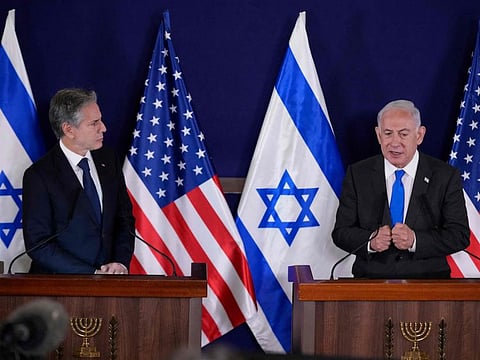 US Secretary of State Antony Blinken (left) and Israel's Prime Minister Benjamin Netanyahu give statements to the media inside The Kirya, which houses the Israeli Defence Ministry, after their meeting in Tel Aviv on October 12, 2023.  