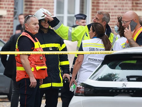 French rescue workers are seen at the site after a teacher was killed and several people injured in a knife attack at the Lycee Gambetta-Carnot high school in Arras, northern France, October 13, 2023.