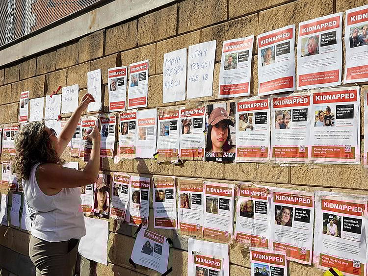 Supporters and family members of Israeli hostages snatched by the militant group Hamas, plaster their images