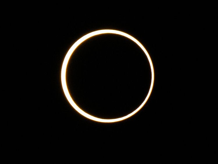 The moon descends over the sun's horizon during an annular solar eclipse on October 14, 2023 in Kerrville, Texas. Differing from a total solar eclipse, the moon in an annular solar eclipse covers part of the sun's light, creating the "ring of fire" effect around the moon.    