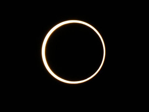 The moon descends over the sun's horizon during an annular solar eclipse on October 14, 2023 in Kerrville, Texas. Differing from a total solar eclipse, the moon in an annular solar eclipse covers part of the sun's light, creating the "ring of fire" effect around the moon.    