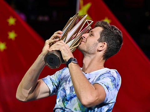 Poland's Hubert Hurkacz celebrates with the trophy after winning against Russia's Andrey Rublev in their final at the Shanghai Masters on Sunday.