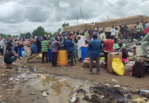 Displaced Sudanese wait to cross into Ethiopia from Sudan's border town of Gallabat, on August 3, 2023.  