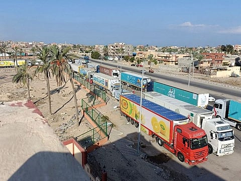 Trucks carrying humanitarian aid for Palestinians wait for the re-opening of the Rafah border crossing to enter Gaza, amid the ongoing conflict between Israel and the Palestinian Islamist group Hamas, in the city of Al Arish, Sinai peninsula, Egypt, October 16, 2023.  