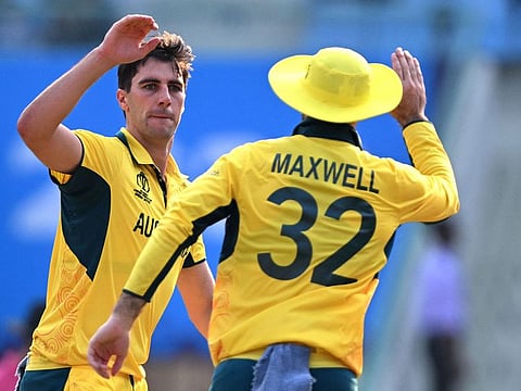 Australian captain Pat Cummins (L) celebrates with Glenn Maxwell after dismissing Sri Lanka's Pathum Nissanka on Monday.