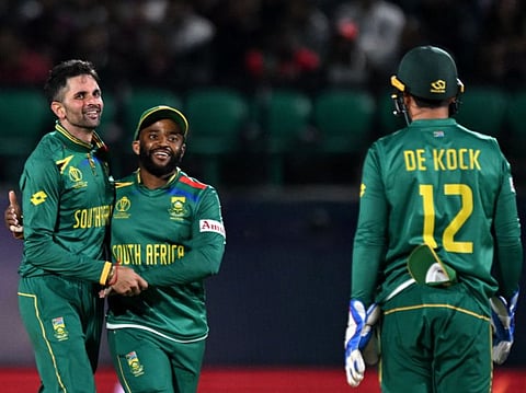 South Africa's Keshav Maharaj (left) celebrates with Quinton de Kock (right) and Temba Bavuma after dismissing Logan van Beek.