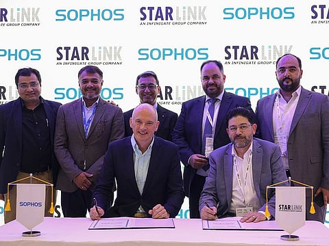 Senior executives from Sophos and StarLink signing the agreement
