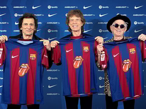 Members of the Rolling Stones, Ronnie Wood, Mick Jagger and Keith Richards pose for a picture as they hold FC Barcelona jerseys with the iconic tongue in Barcelona, Spain.