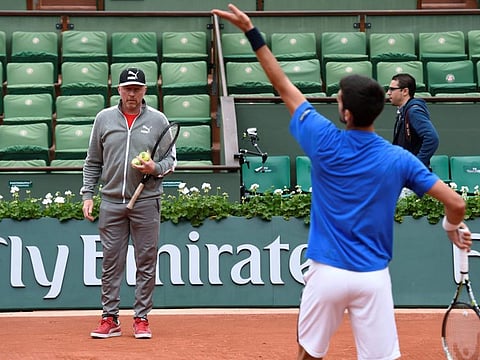 Coach Boris Becker watches as Serbia's Novak Djokovic trains at 2016 French Open in Paris. The German star coached Djokovic from 2013 to 2016, helping the Serb win six Grand Slams and 14 Masters 1000 titles.