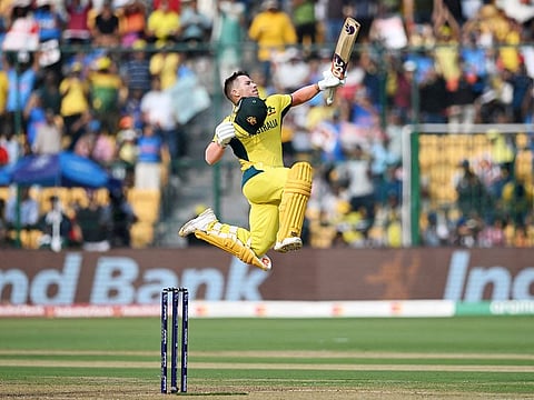 Australia's David Warner celebrates after scoring a century during the 2023 ICC Men's Cricket World Cup ODI match against Pakistan at the M. Chinnaswamy Stadium in Bengaluru on October 20, 2023. 